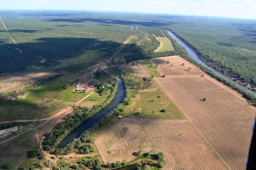 an aerial shot of a homestead and river