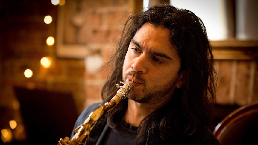 Ariel Azzimonti practices playing saxophone at his home in Sydney.