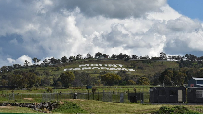 The words 'Mount Panorama' spelled out on the side of the hill from a distance.