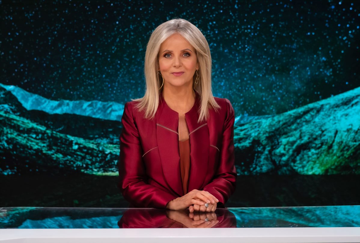 Beverley O'Connor smiles at the camera while sitting at a desk.