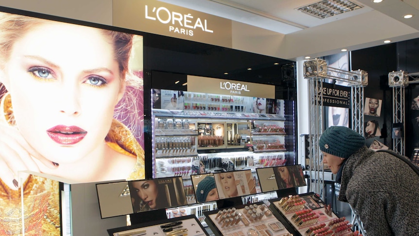 A woman looks at L'Oreal cosmetics.