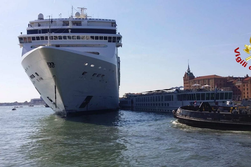 A Cruise ship next to the smaller ship it hit in the Giudecca Canal in Venice.