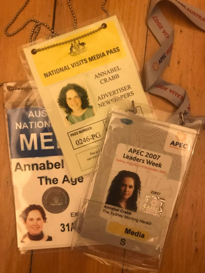 Three press passes with Crabb photos on them from different years.