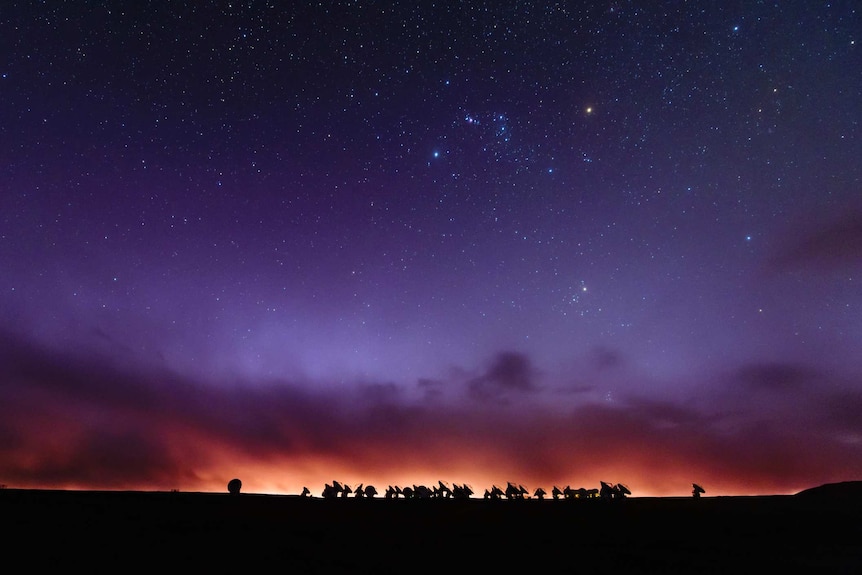 ALMA telescopes silhouetted against skyline at sunset in Chile
