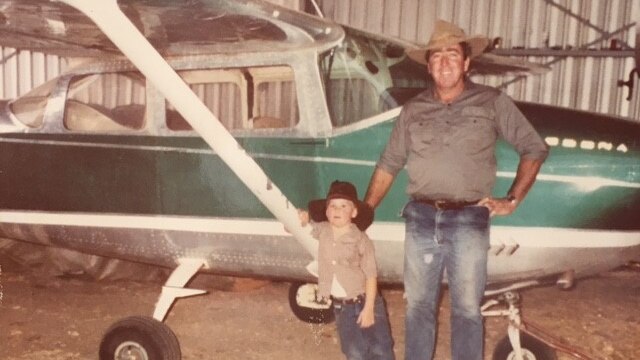 Bill Ballinger and his son Rupert in front of their light plane.