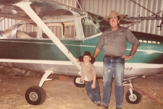 Bill Ballinger and his son Rupert in front of their light plane.