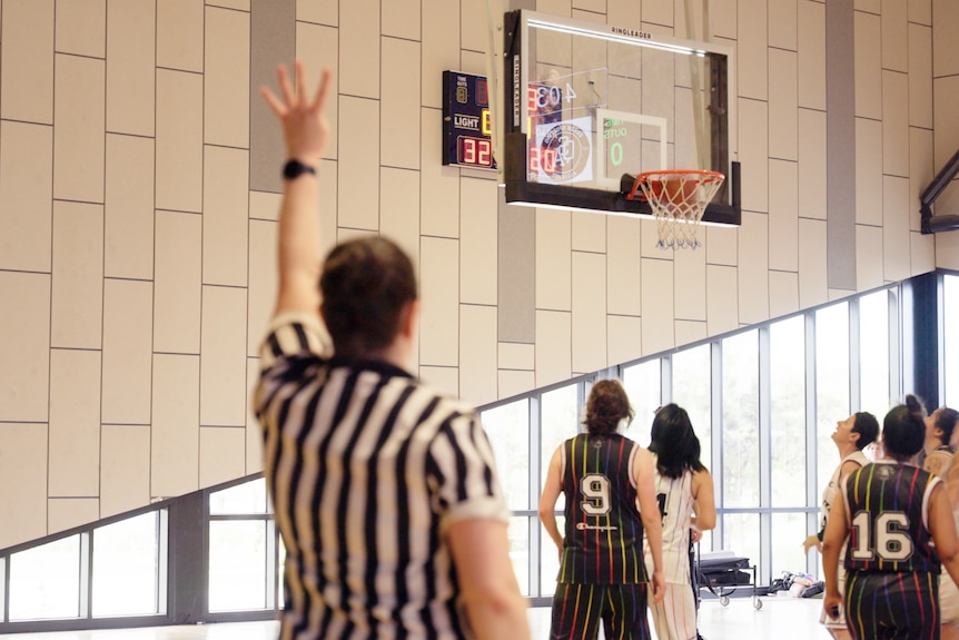 The referee awards a four point shot in the QSA basketball tournament
