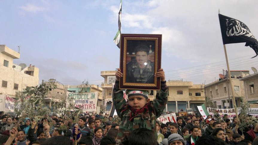 Demonstrators protest against Syria's president Bashar al-Assad after Friday prayers in Binsh.
