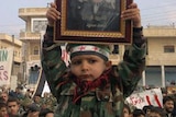 Demonstrators protest against Syria's president Bashar al-Assad after Friday prayers in Binsh.