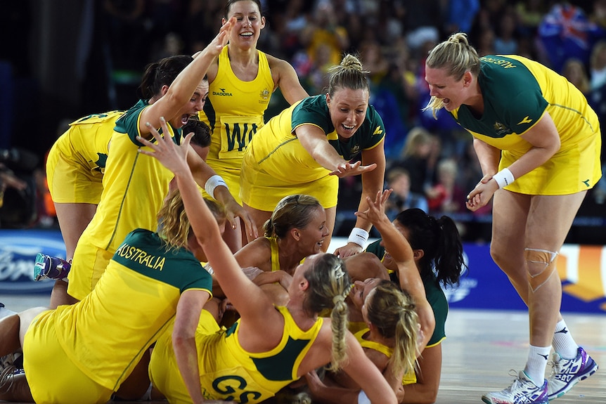 The Diamonds hug and celebrate their gold medal win.