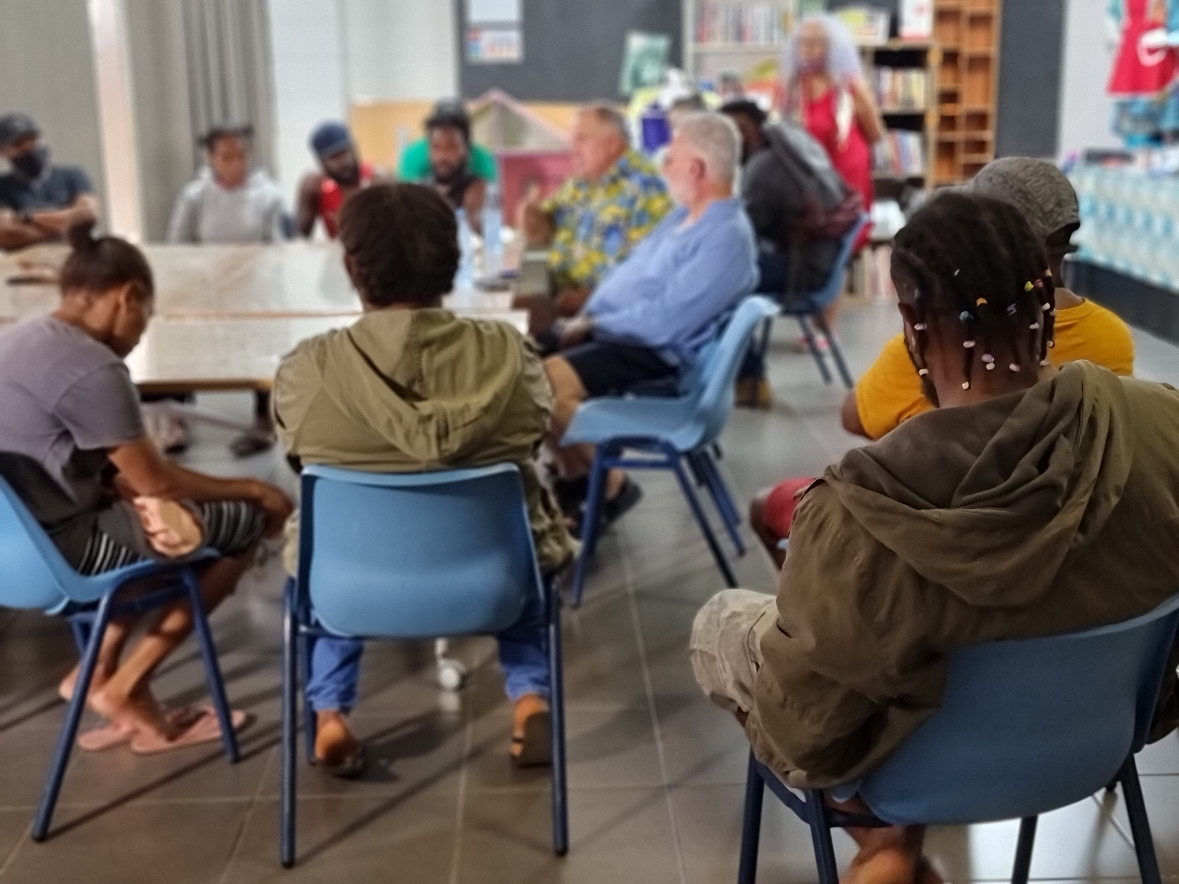 A group of workers sitting down with their back's to the camera