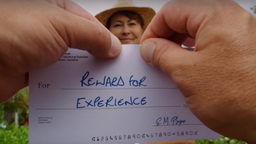 A pair of hands prepares to tear up a piece of paper labelled "reward for experience".