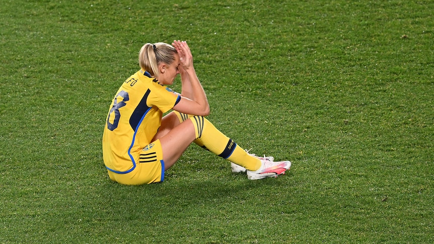 Sweden's Fridolina Rolfo sits on the ground with her head in her hands at the Women's World Cup.
