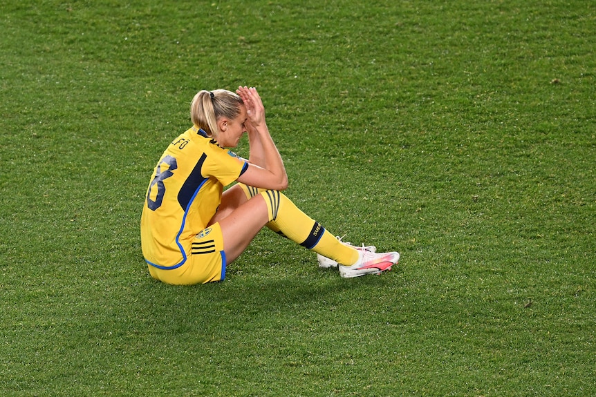 Sweden's Fridolina Rolfo sits on the ground with her head in her hands at the Women's World Cup.