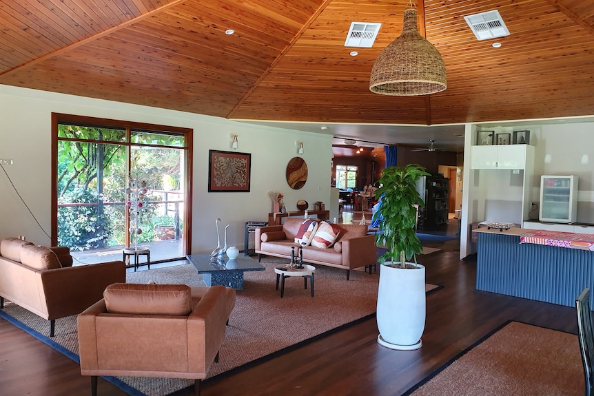 A living room with wooden panels on the ceiling.