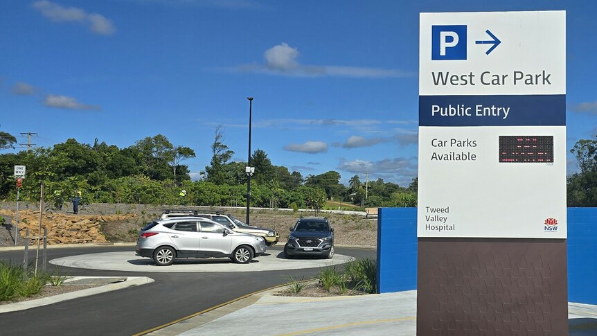 Three cars parked on a round about because there is a lack of car parking spaces at Tweed Valley Hospital.