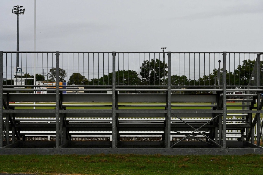 An empty grandstand overlooking Salter Oval in Bundaberg on a rainy day.