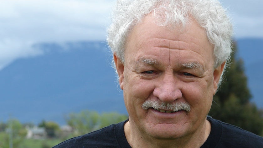 A headshot of Michael Mansell, smiling.