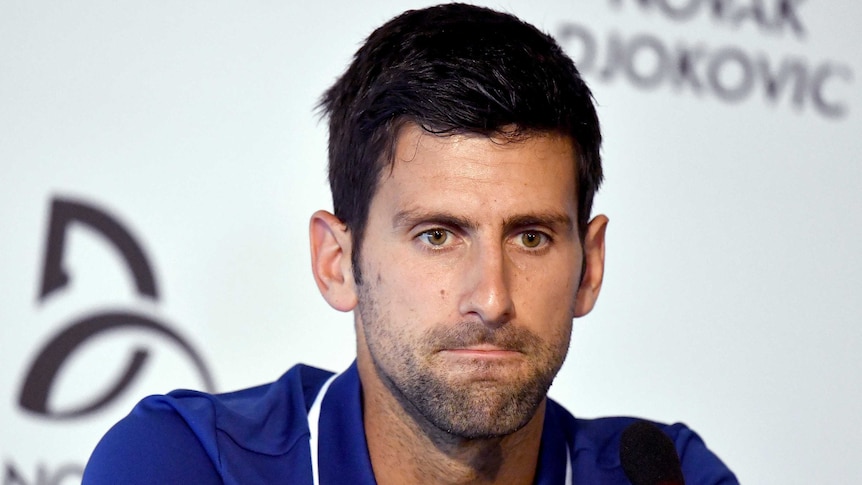 Novak Djokovic looks concerned at a press conference