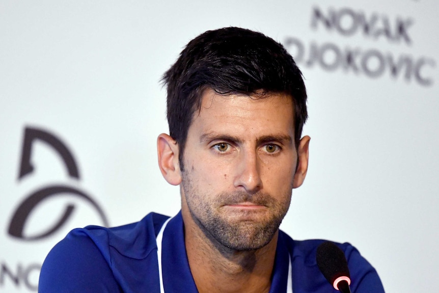 Novak Djokovic looks concerned at a press conference