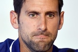 Novak Djokovic looks concerned at a press conference