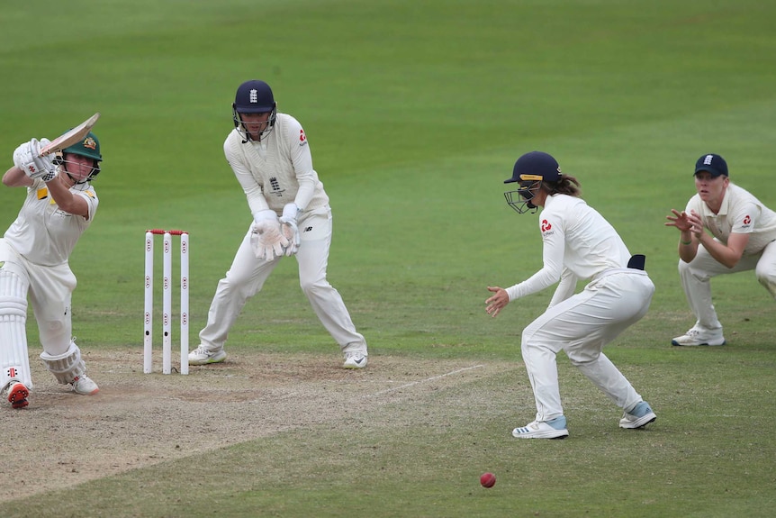 A slip and silly point are in place as Beth Mooney drives through the off-side off the front foot.