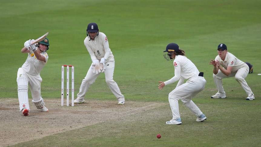 A slip and silly point are in place as Beth Mooney drives through the off-side off the front foot.