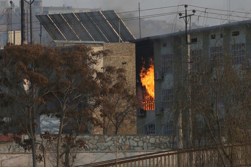 Flames billow from a building.