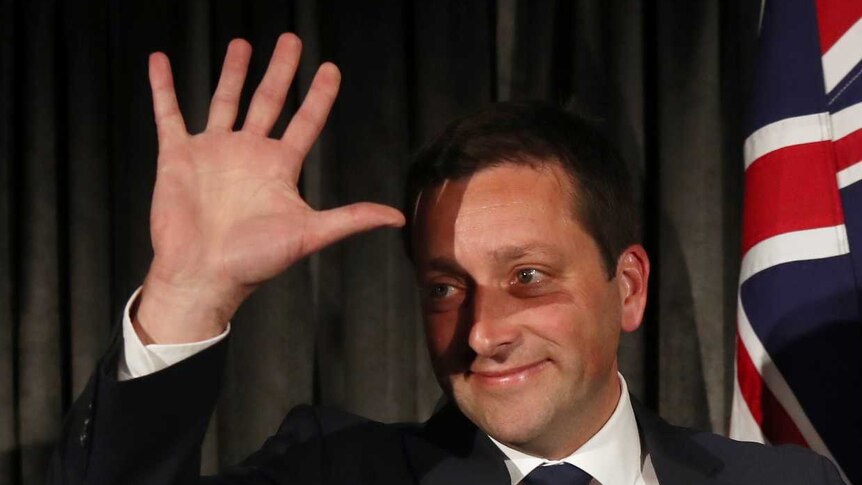 Matthew Guy waves to the Liberal Party faithful with his wife Renae by his side.