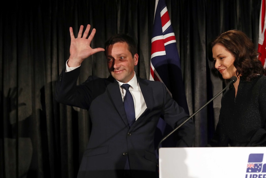 Matthew Guy waves to the Liberal Party faithful with his wife Renae by his side.