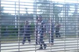 Authorities are seen shouting at men at the Manus Island detention centre.