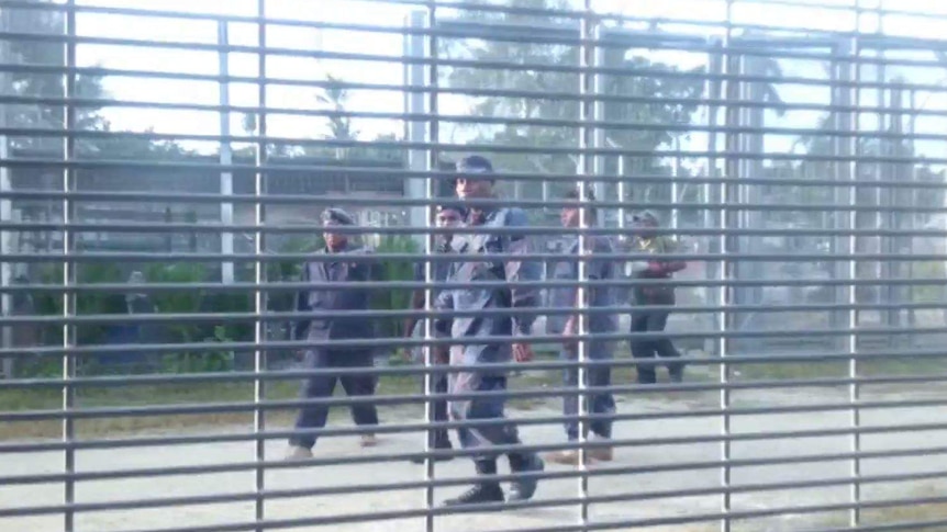 Authorities are seen shouting at men at the Manus Island detention centre.