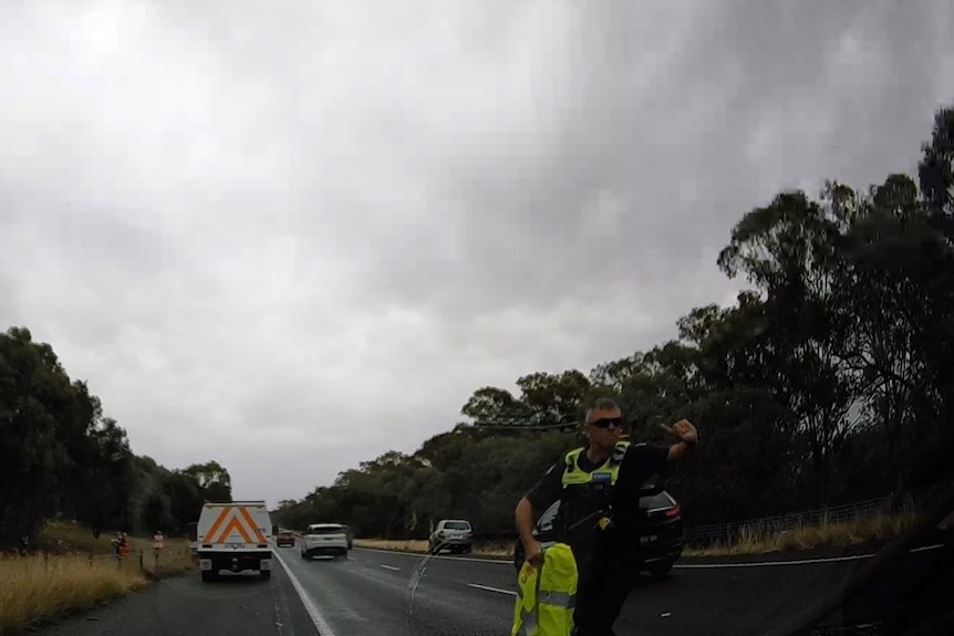 A police officer in high-vis directing traffic.