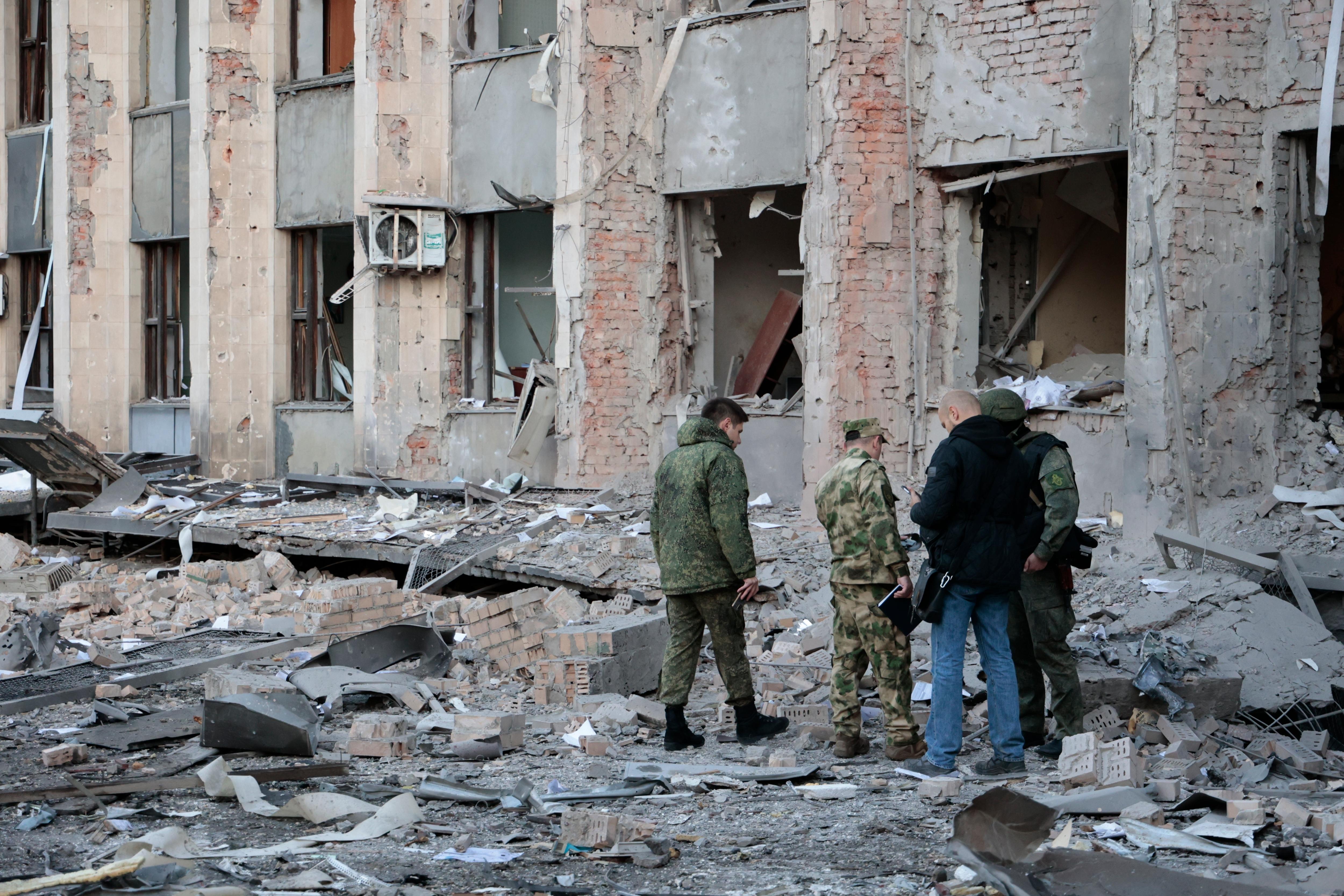 Soldiers inspecting a shelled building. 