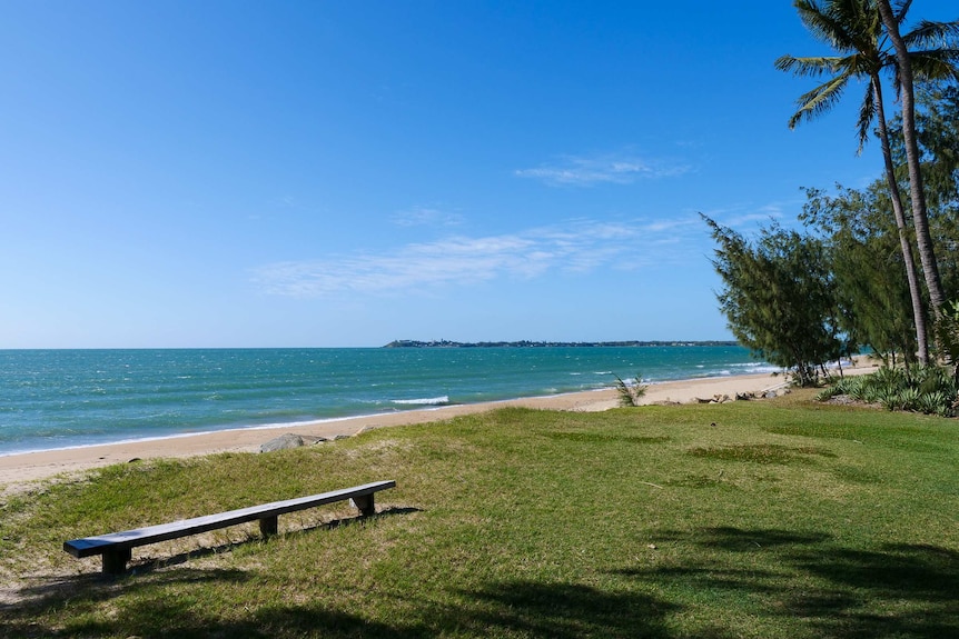 View of a beach and the ocean with a headland behind