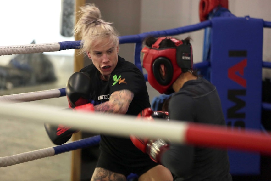 Ahead of her second bare knuckle bout Bec Rawlings protects her hands using conventional boxing gloves in the gym.