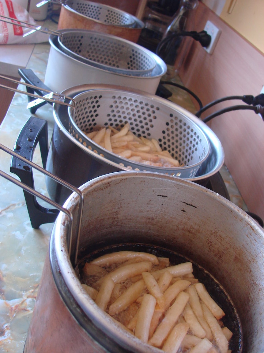 Chips cooking in oil in a kitchen