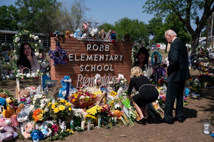 Joe Biden and Jill Biden in black lay flowers at the memorial for those killed at Robb Elementary in Uvalde Texas