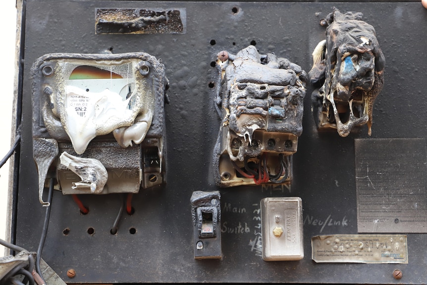 Melted electrical fuses in a burnt wooden box