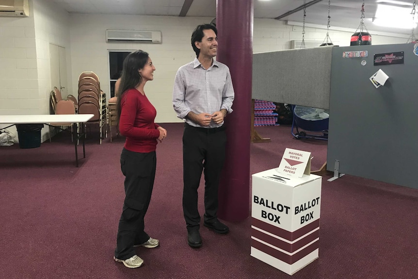 Acting Fraser Coast Regional Council Mayor George Seymour stands with his wife next to ballot box at Hervey Bay PCYC.
