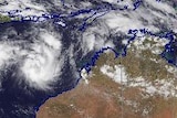 A satellite image of weather activity in and around Australia, showing two potential tropical cyclones off the north coast.