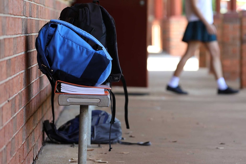 High school student's school bags outside the classroom at an educational facility.