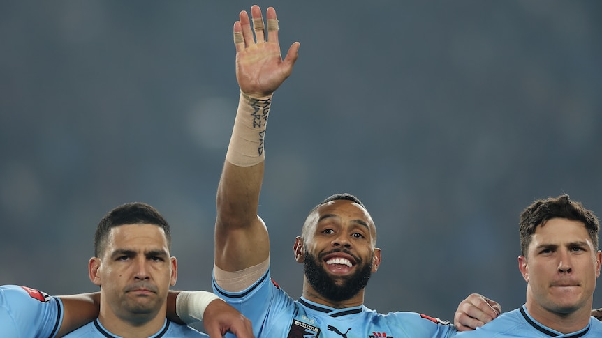 Josh Addo Carr holds up his hand and smiles