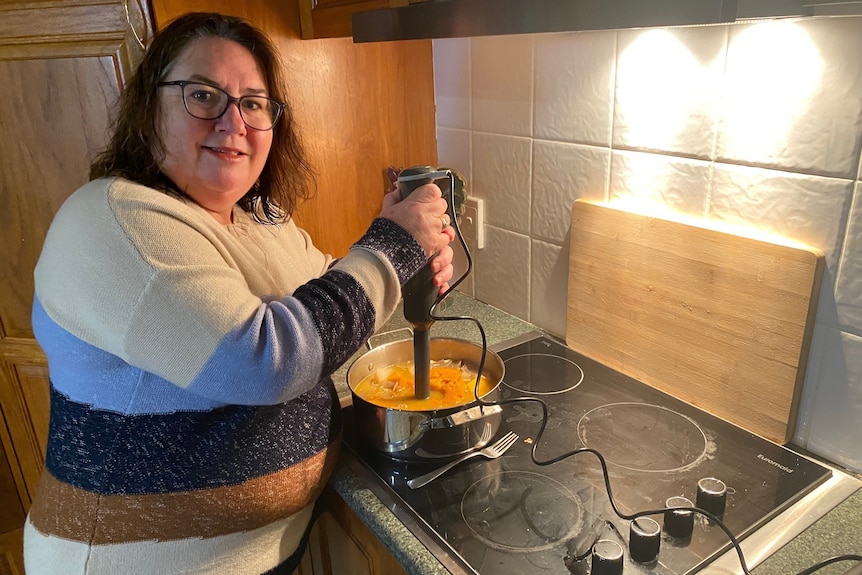 woman preparing food on a stove