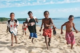 Children run on Palm Island's beach