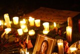 A picture of Gabrielle Giffords is surrounded by candles