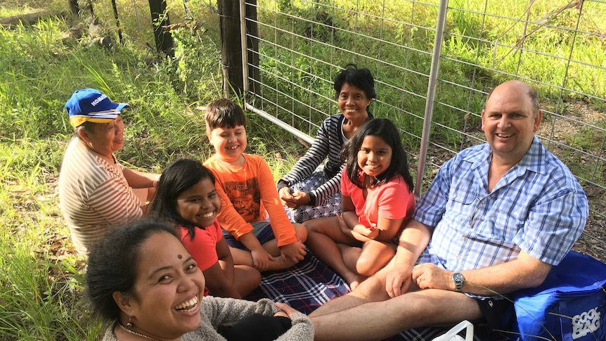 A family waits for the Pacific Highway to reopen