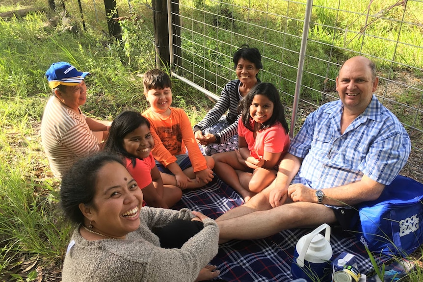 A family waits for the Pacific Highway to reopen