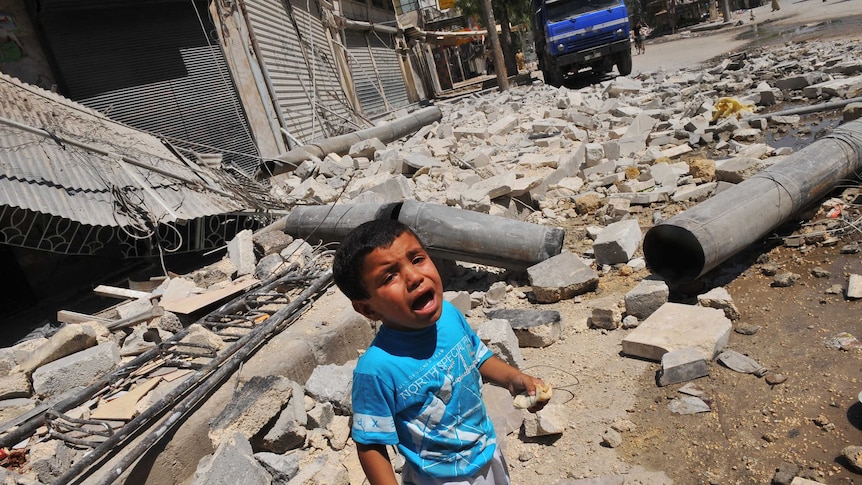 Boy cries in Aleppo on first day of Eid