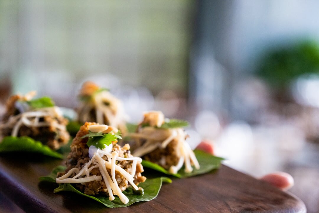 Delicious canapes served on betel leaves.